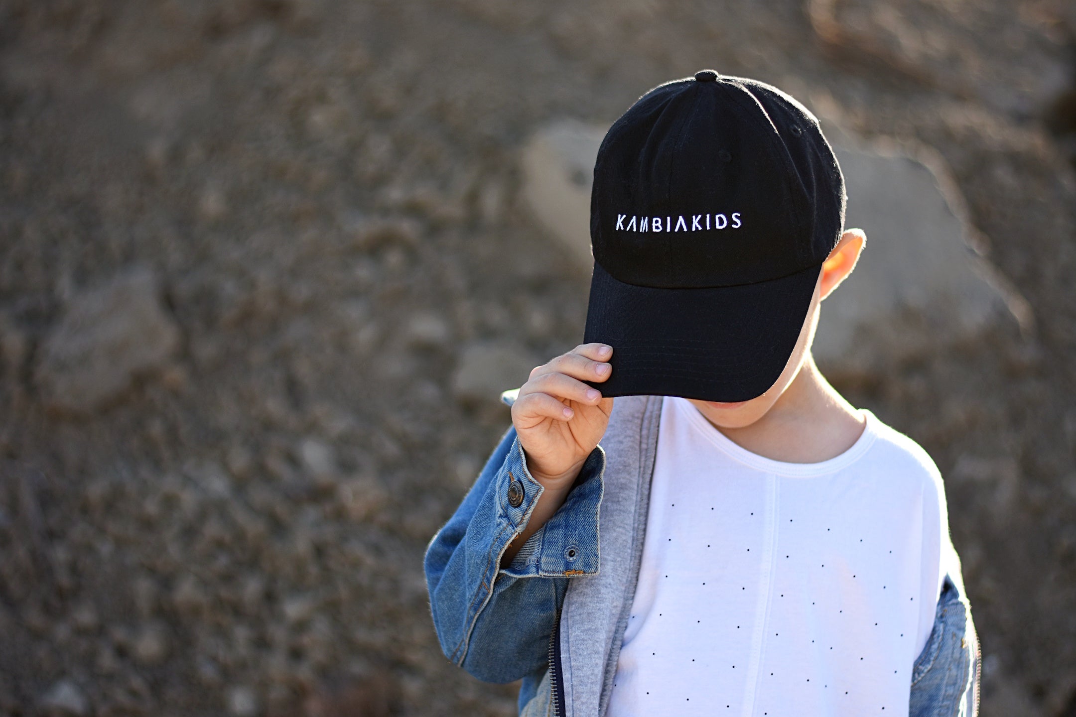Black dad hat with the Kambia Kids logo on the front